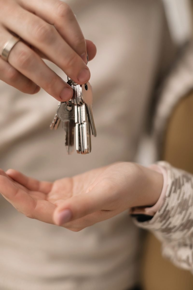 One hand dropping a ring of keys into another open hand