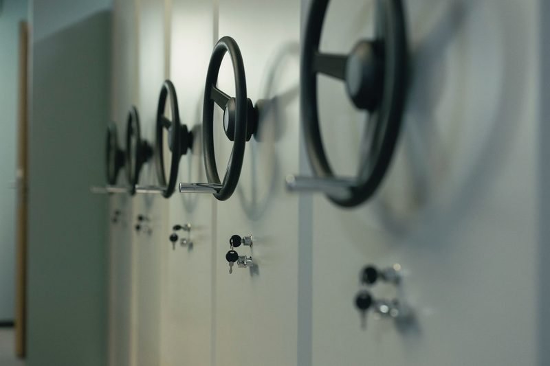 A row of pale green safes with spoked handles and key locks